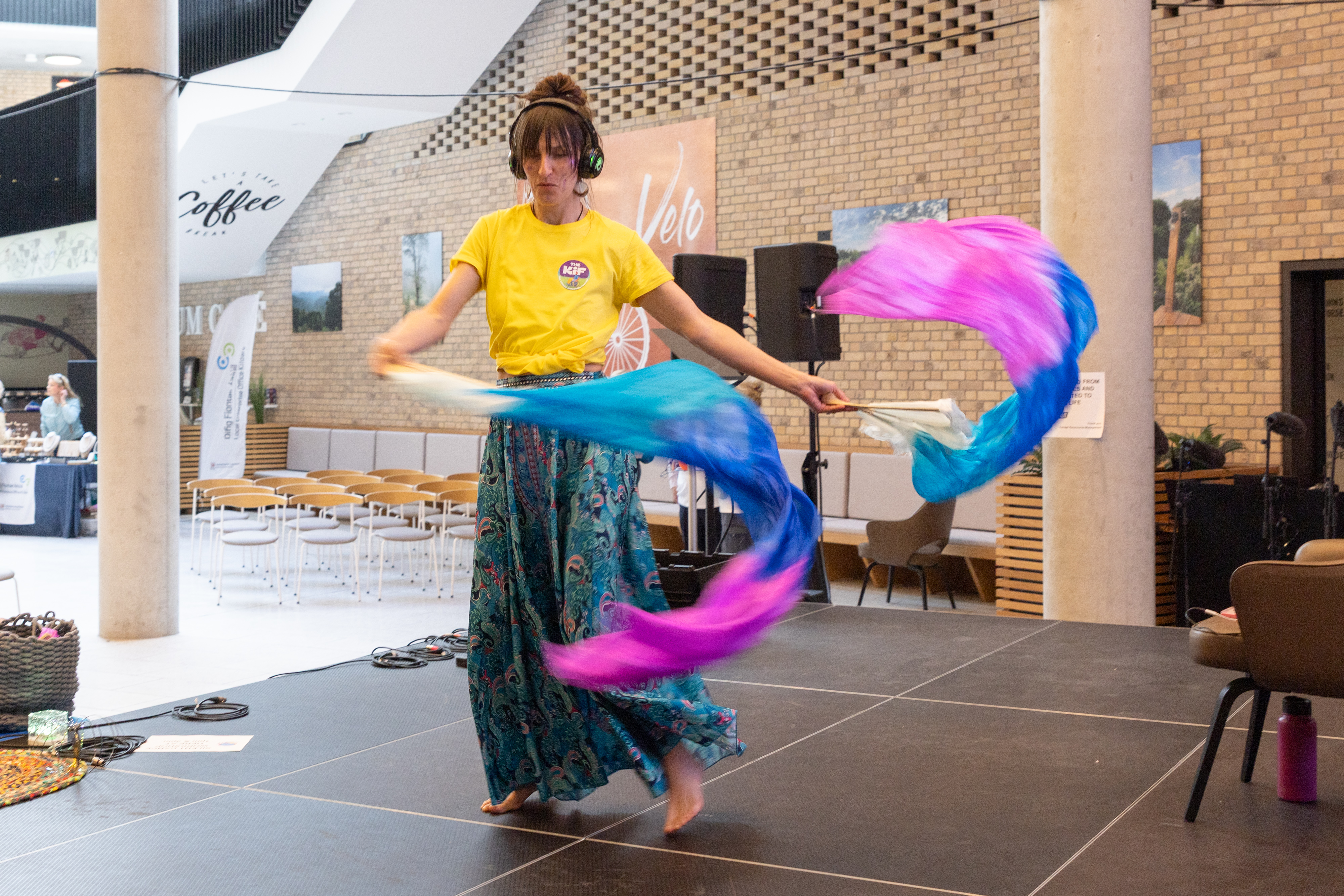 Person moving colourful fabric.